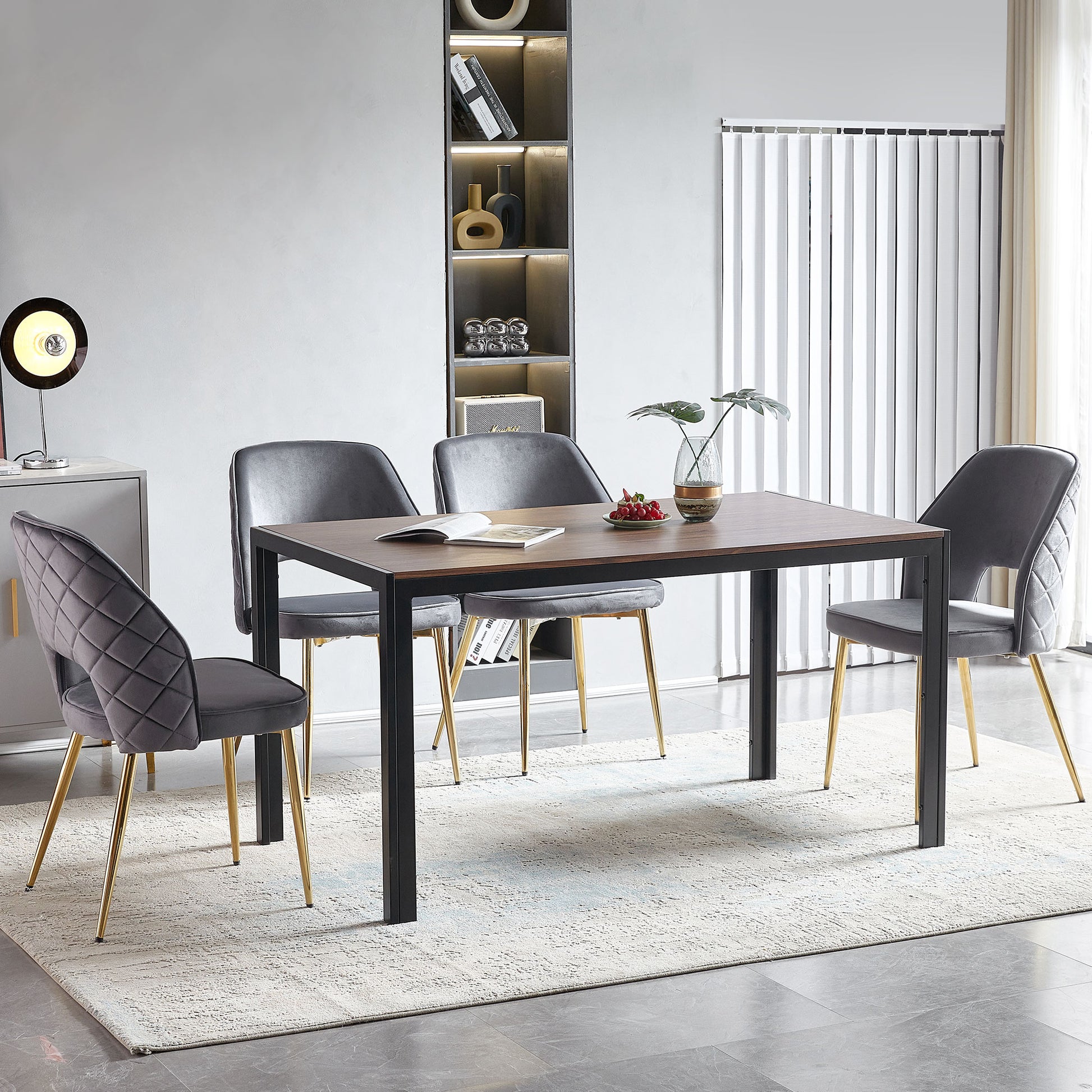 Luxurious grey velvet dining chair with quilted back and gold legs for a modern dining room