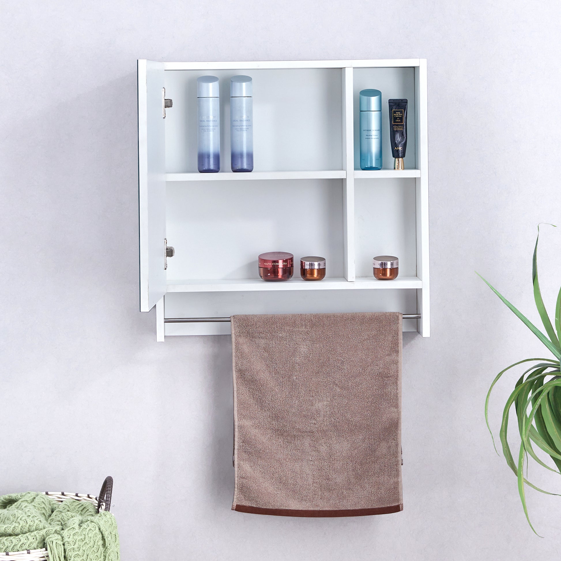 White wallmounted bathroom cabinet with towel bar holding a brown towel