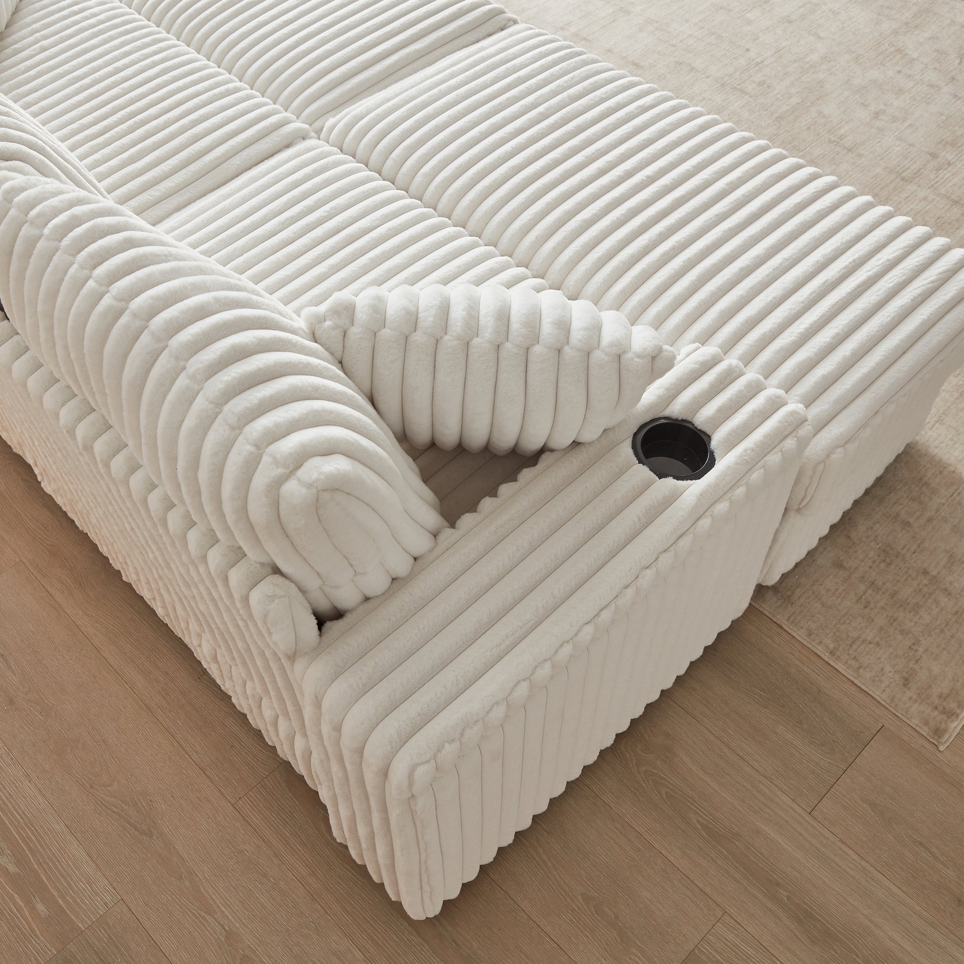 Plush ivory corduroy sofa with builtin cup holders and plush cushions