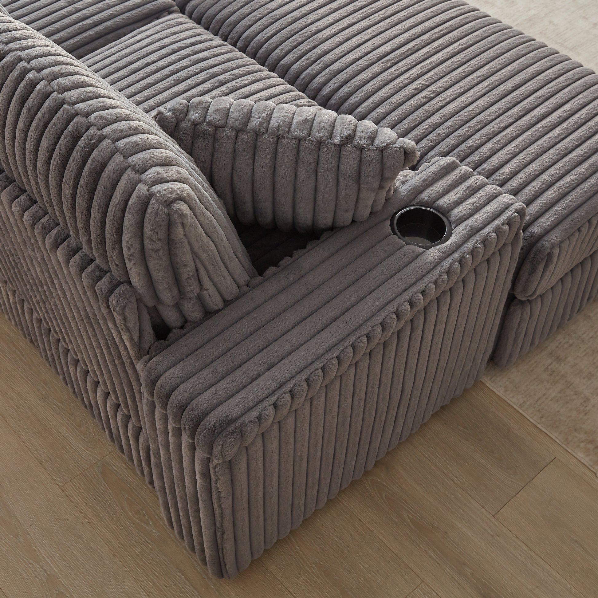 Plush grey corduroy recliner chair with builtin cup holder perfect for home theater