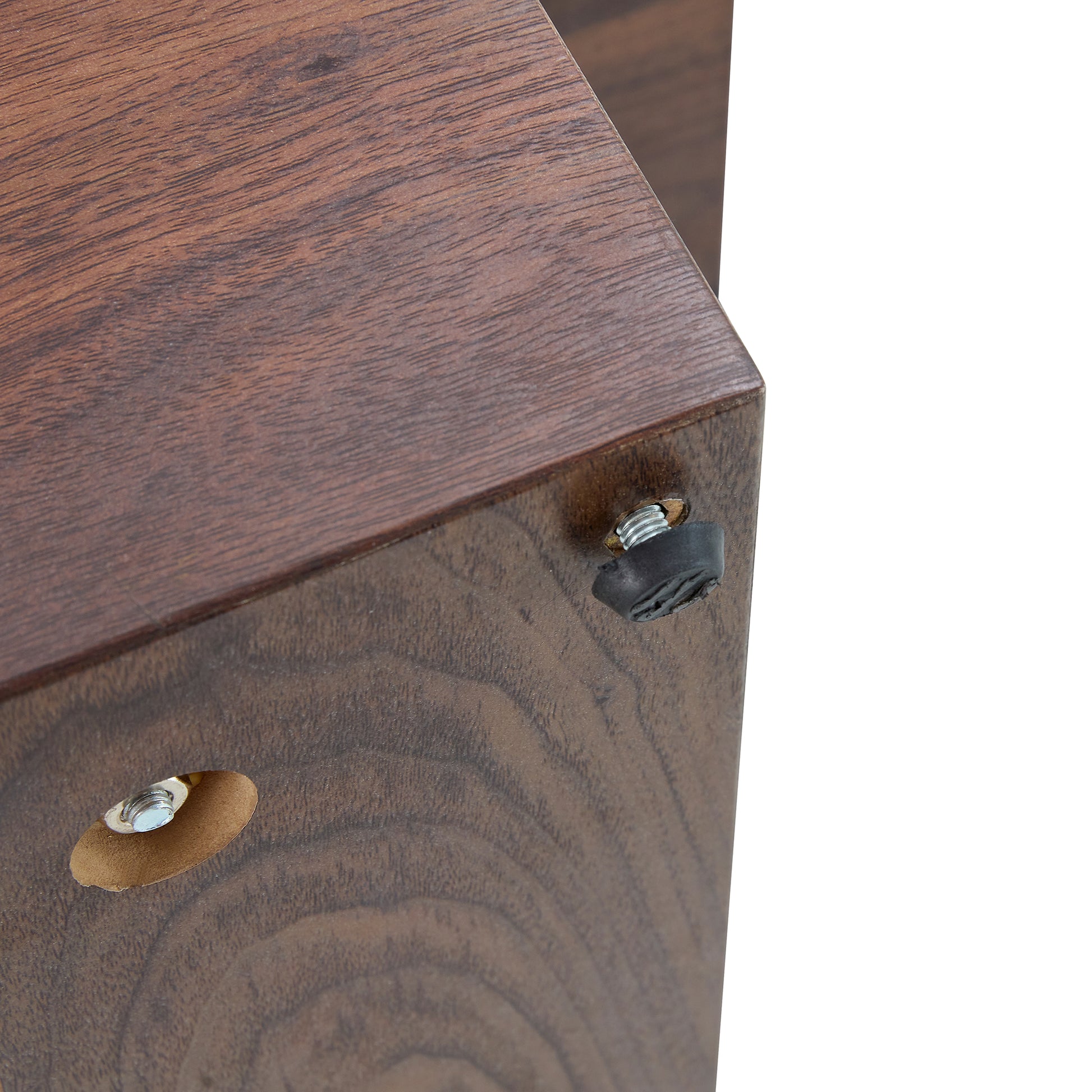 Dark wood veneer shelf corner with black rubber foot and metal screw