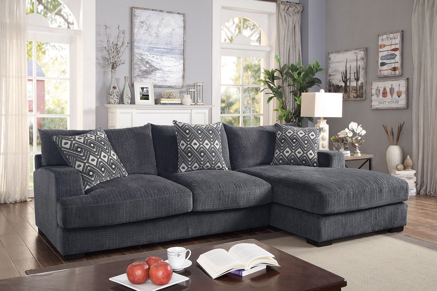 Dark charcoal grey fabric sectional sofa with geometric pattern pillows