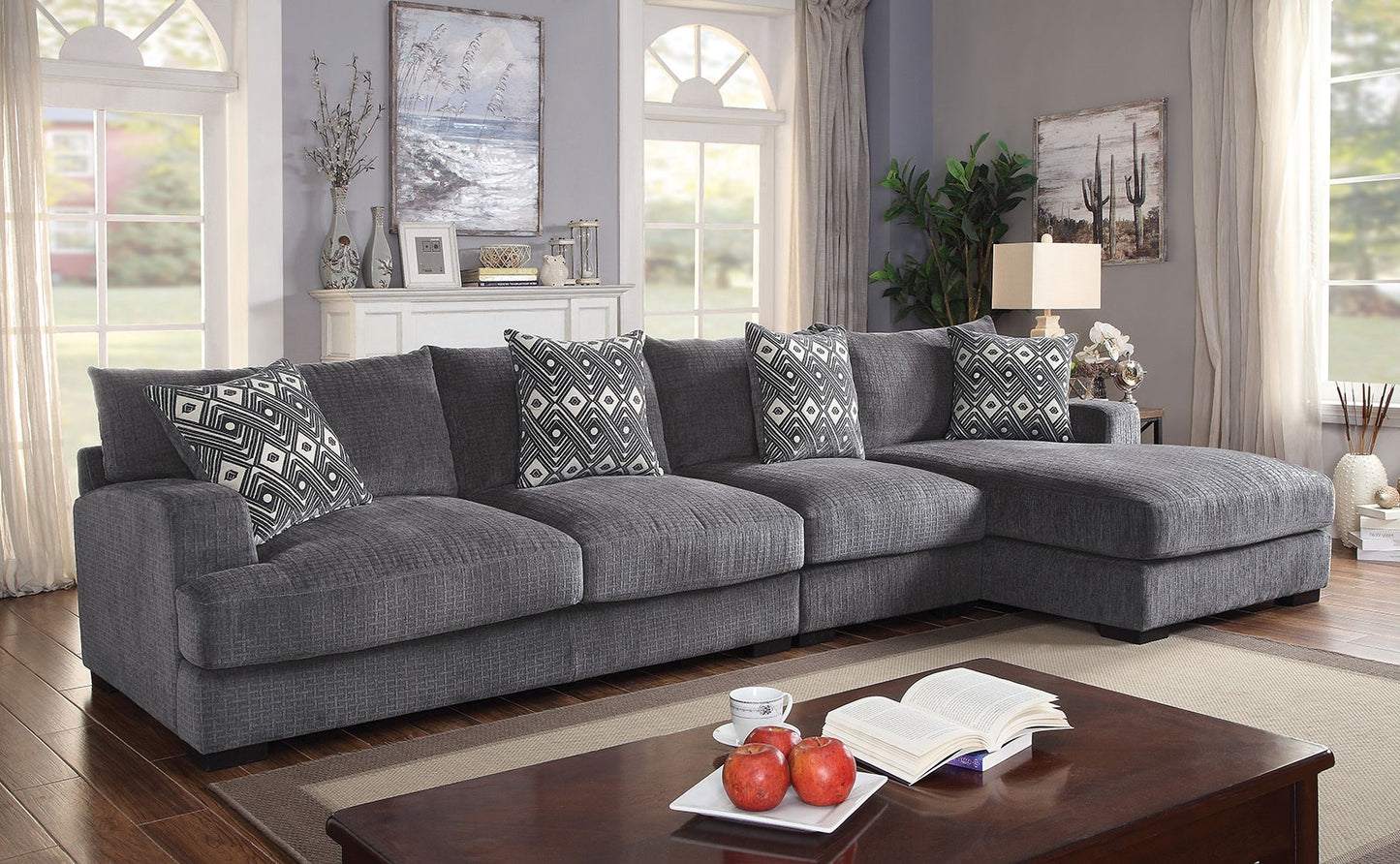 Deep gray fabric sectional sofa with modern geometric accent pillows perfect for living rooms