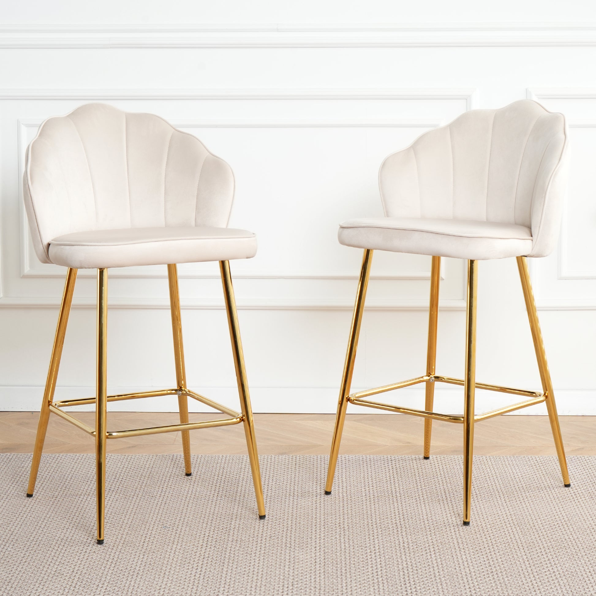 Two cream velvet scallop back bar stools with gold legs
