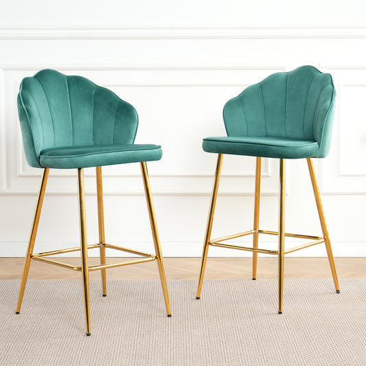 Two teal velvet bar stools with gold legs featuring scalloped backs and padded seats