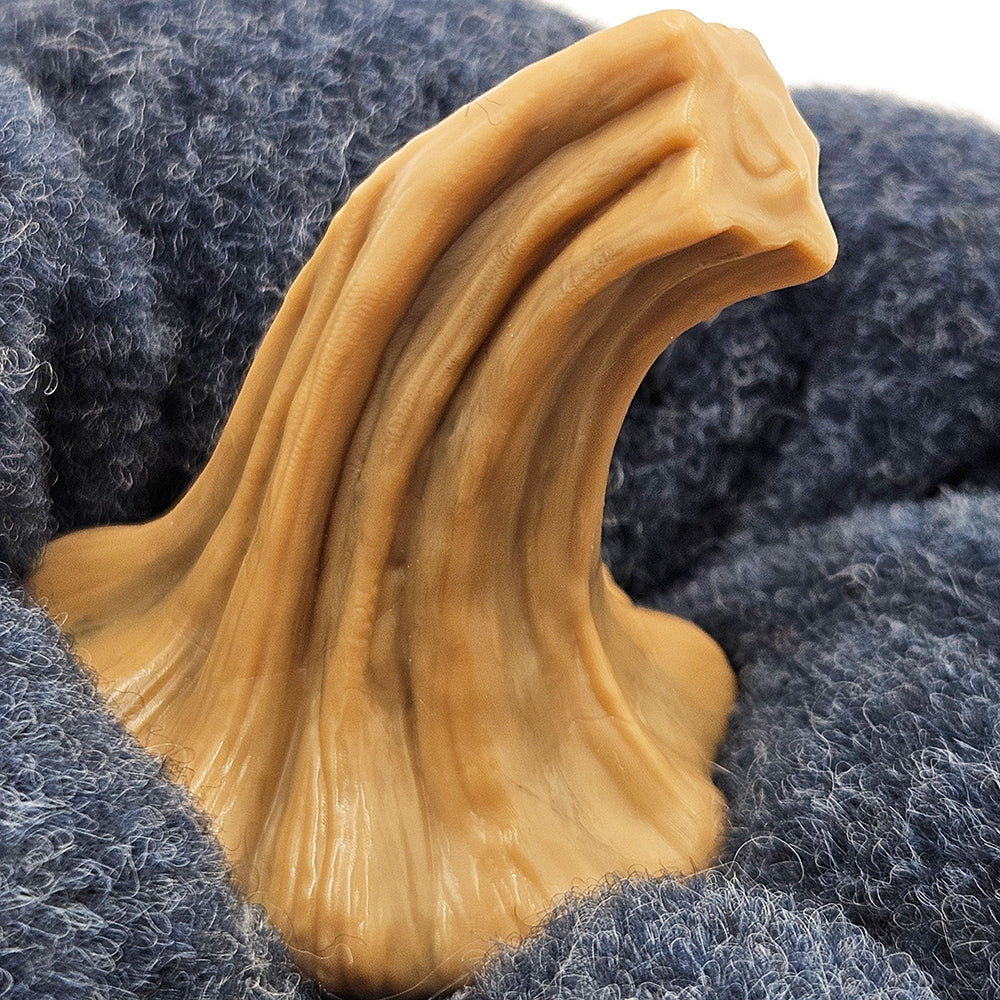 Closeup of a realistic rubber duck bill with textured surface on blue plush fabric