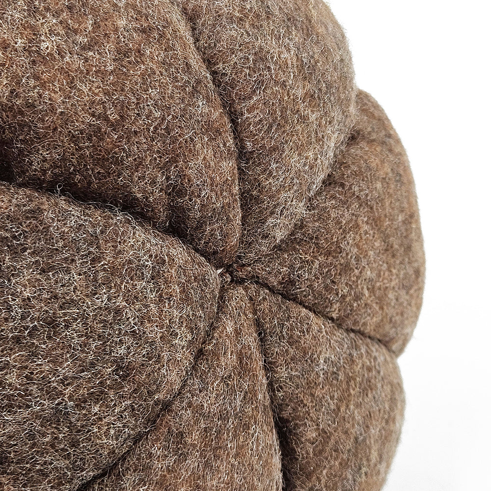 Closeup of a brown felt bean bag chair showing textured stitching detail