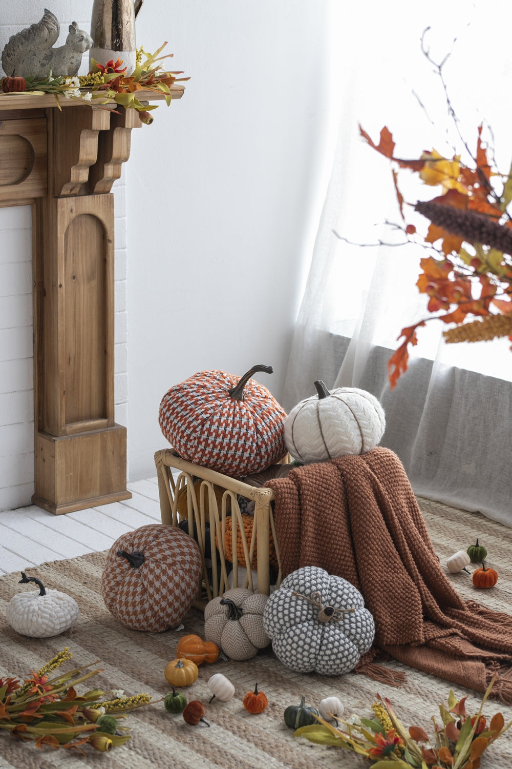 Textured orange and white knit pumpkin decor on woven basket
