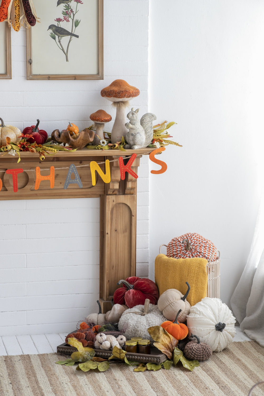 Orange and brown mushroom decor with gray squirrel statue on mantelpiece