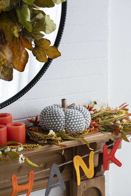 Gray and white knit pumpkin with jute stem ideal for autumn decor
