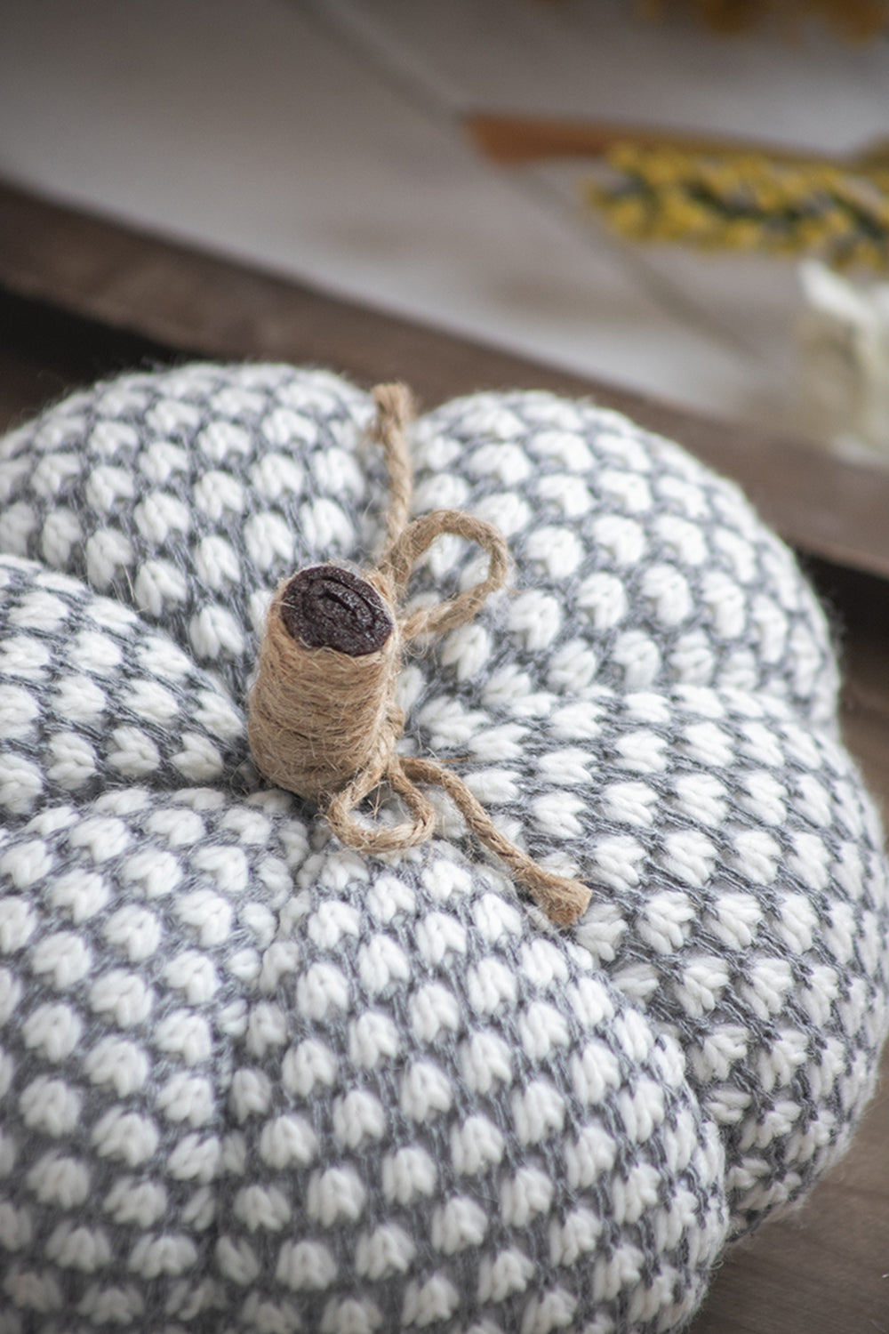 Soft knit pumpkin decor in grey and white textured pattern with twine stem