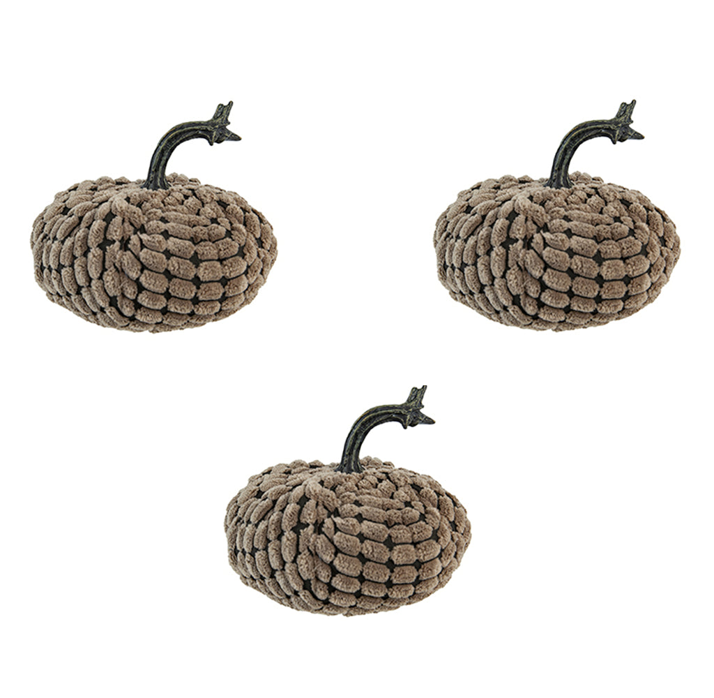 Three plush brown pumpkins with dark brown textured stems arranged on a white background