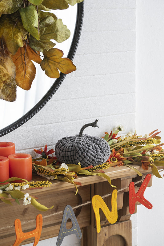Gray knit pumpkin with textured fabric and curved stem perfect for fall decor