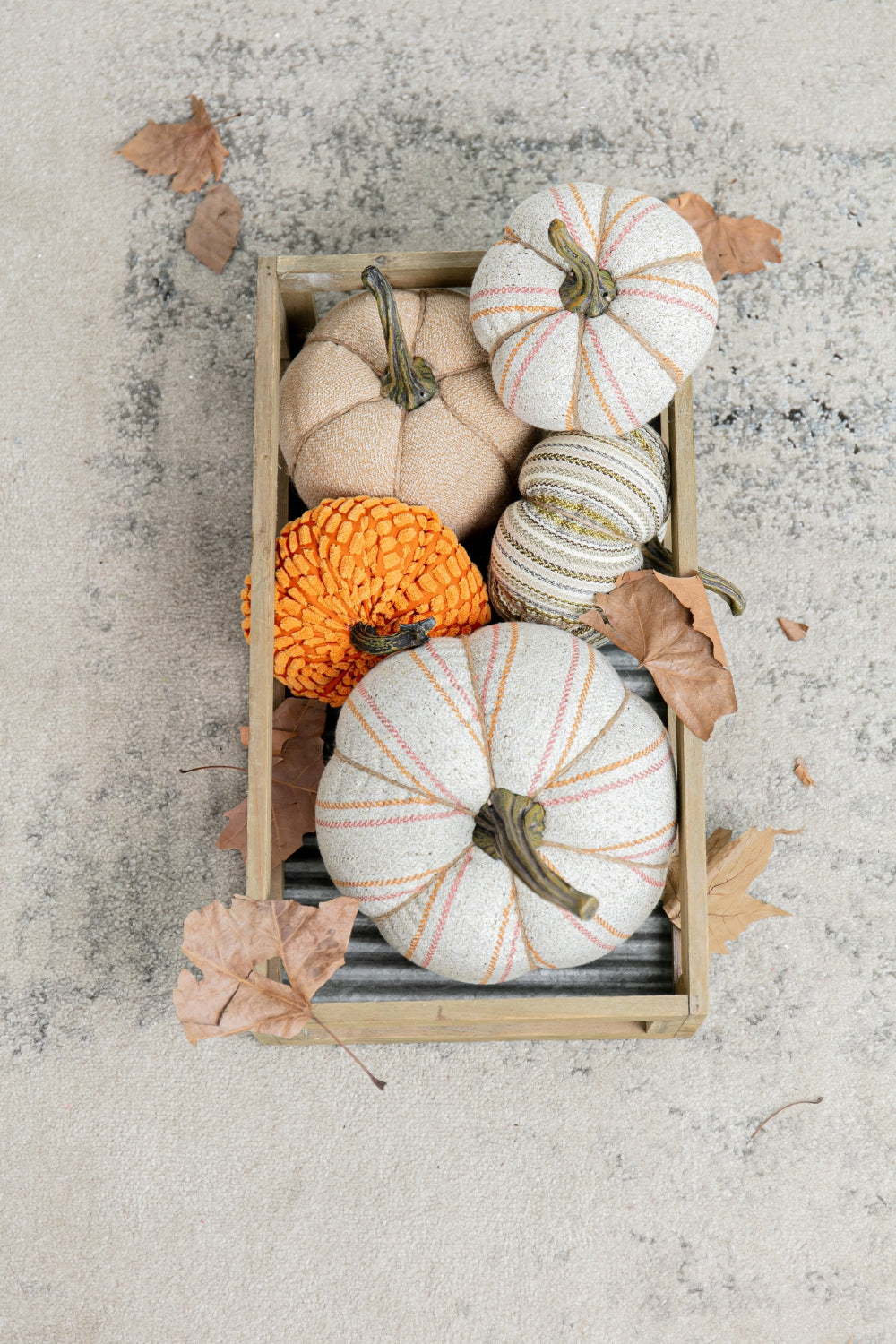 Set of  decorative fabric pumpkins in a wooden crate for autumn decor