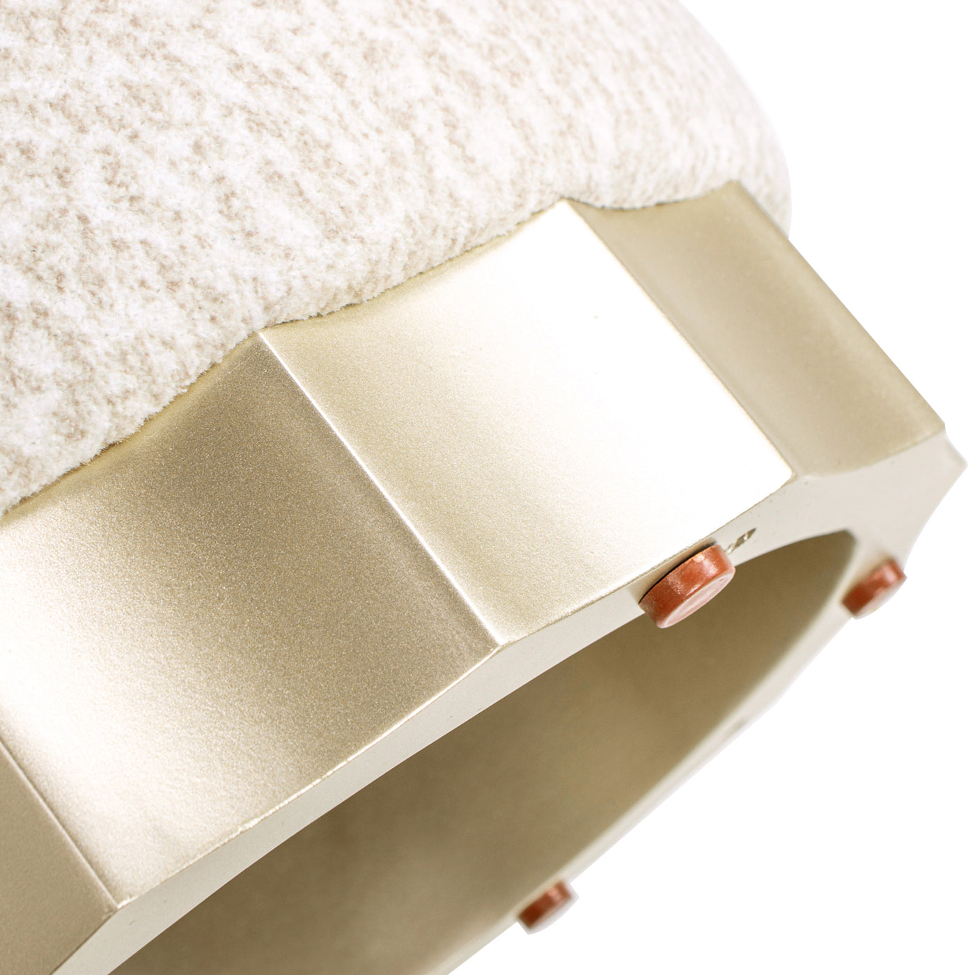 Cream textured fabric ottoman with a geometric gold base and protective floor pads