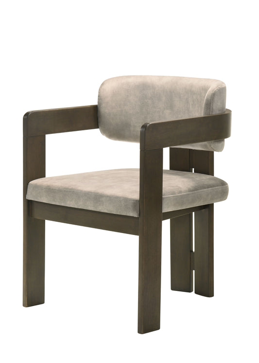 Modern accent chair with plush grey velvet upholstery and dark wood frame