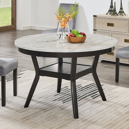 Round marble dining table with dark wood base and subtle veining seating four