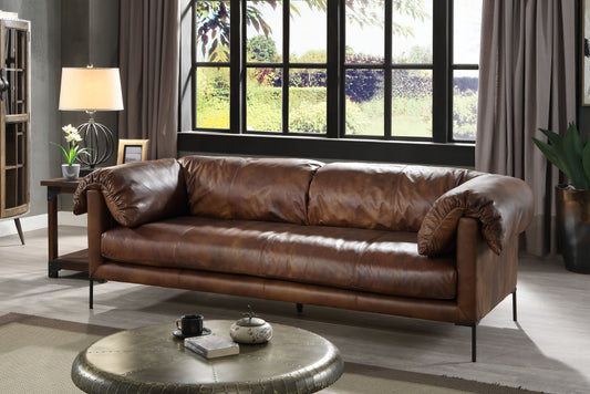 Distressed brown leather sofa with deep seats and plush cushions ideal for a cozy living room setting