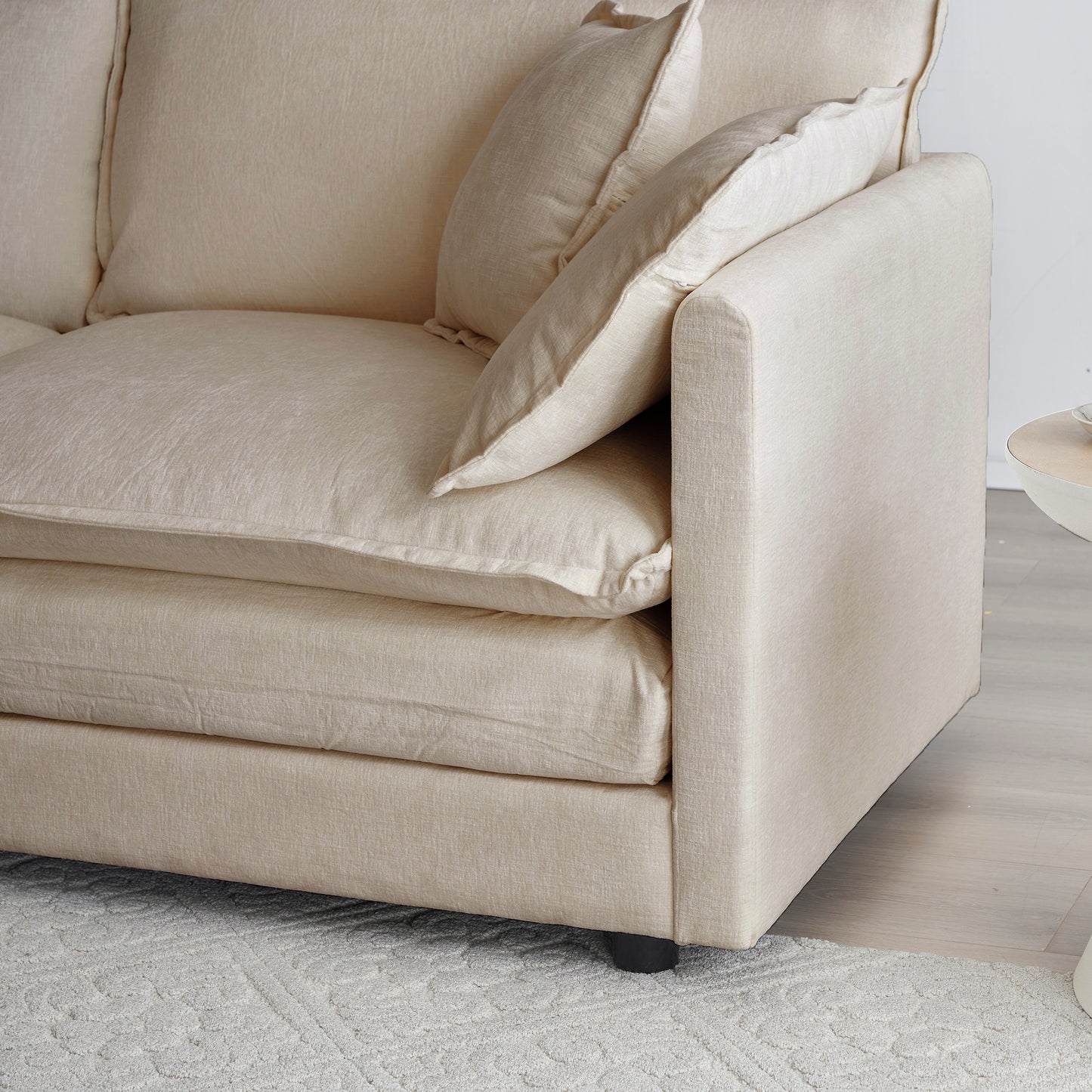 Comfortable cream linen sofa with plush seat cushions and accent pillows