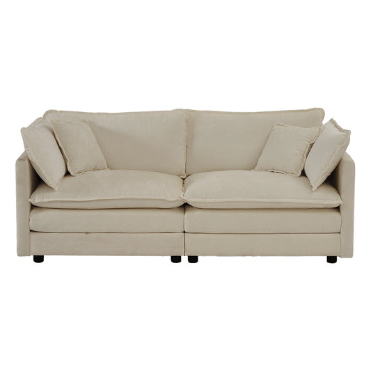 Plush beige fabric sofa with deep seating and four accent pillows