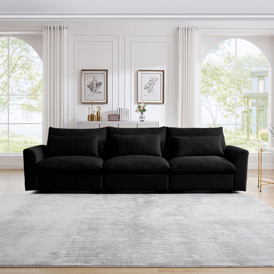 Plush black corduroy sofa with three deep seats and matching throw pillows