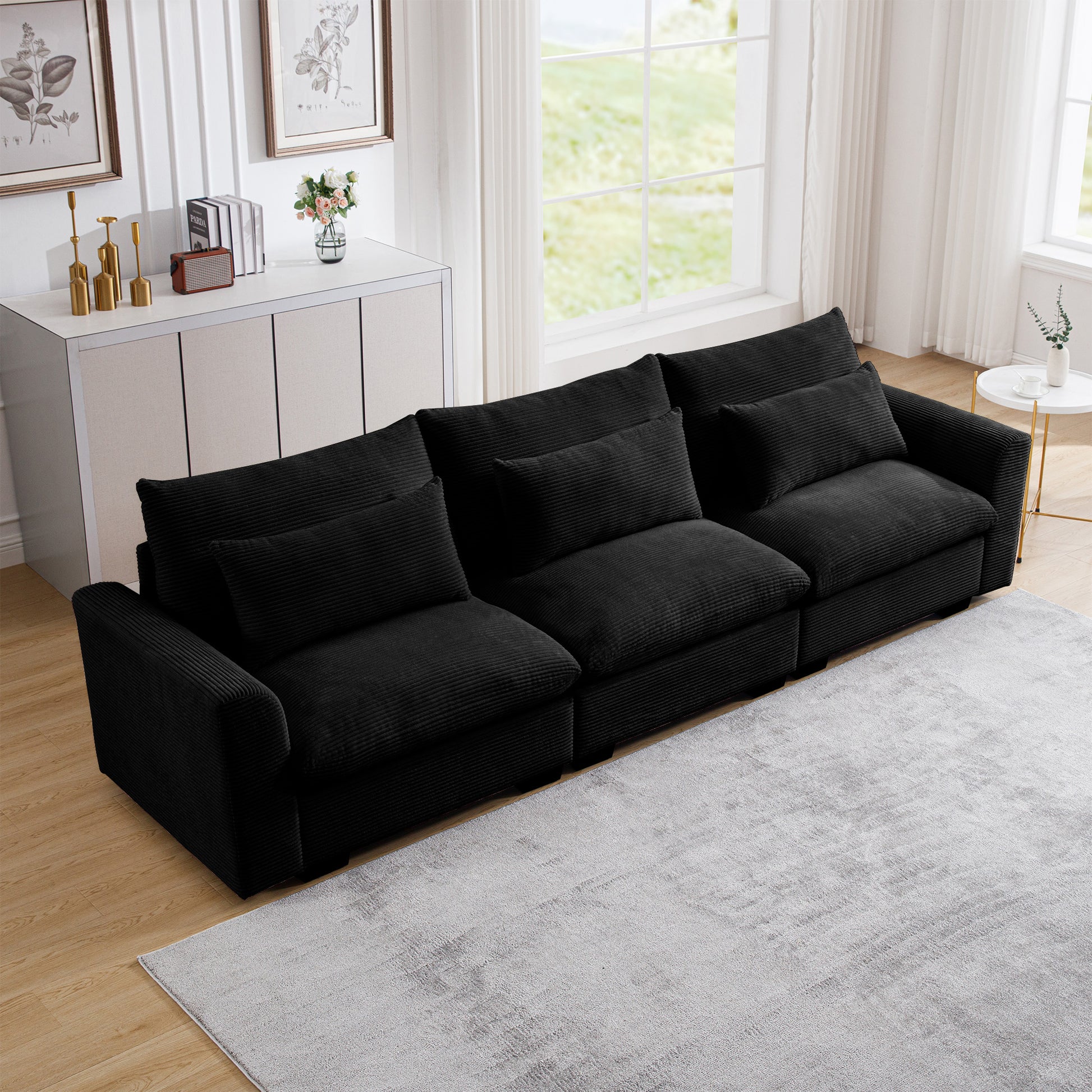 Black corduroy sectional sofa with plush cushions perfect for a modern living room