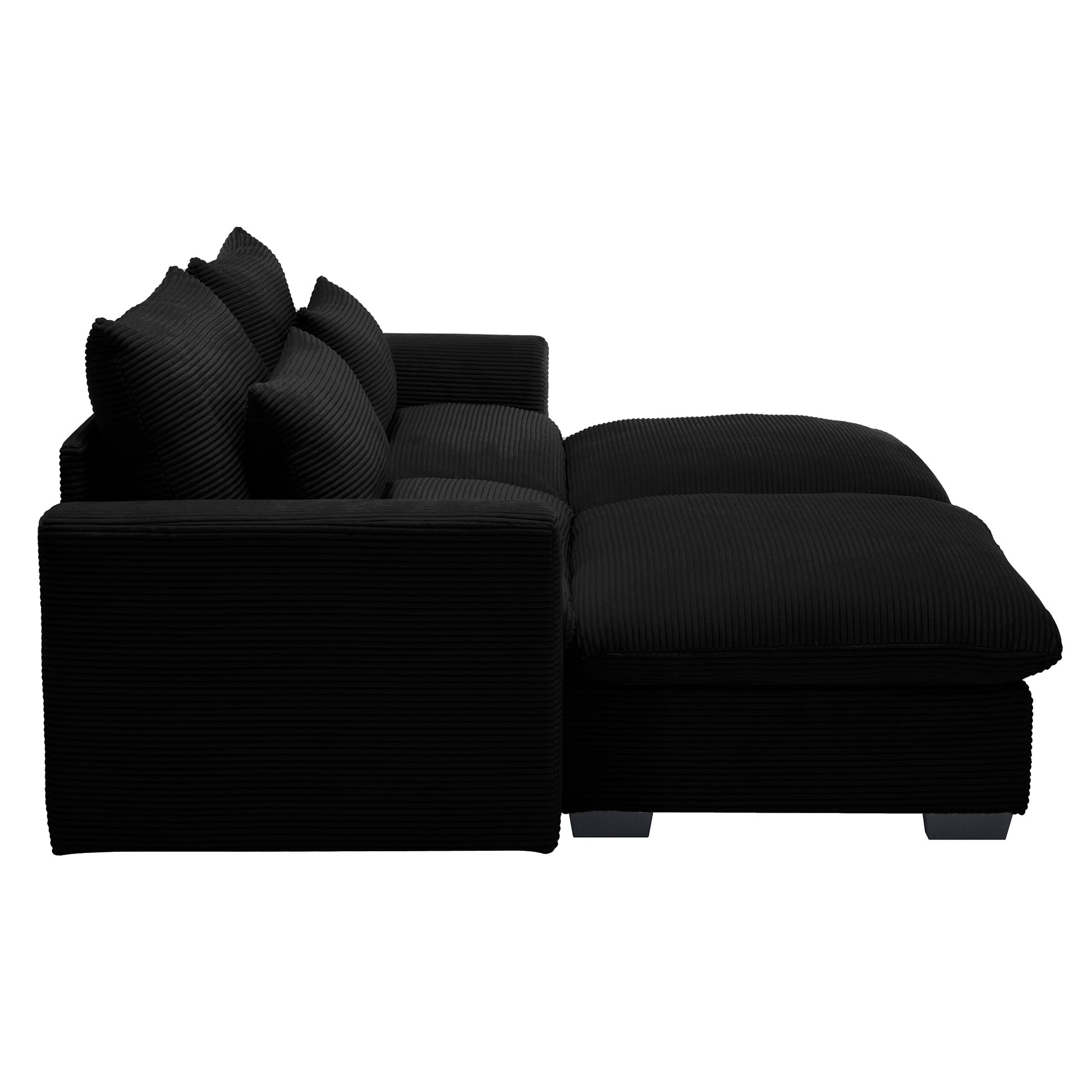 Black corduroy sofa with chaise and plush pillows for a modern living room