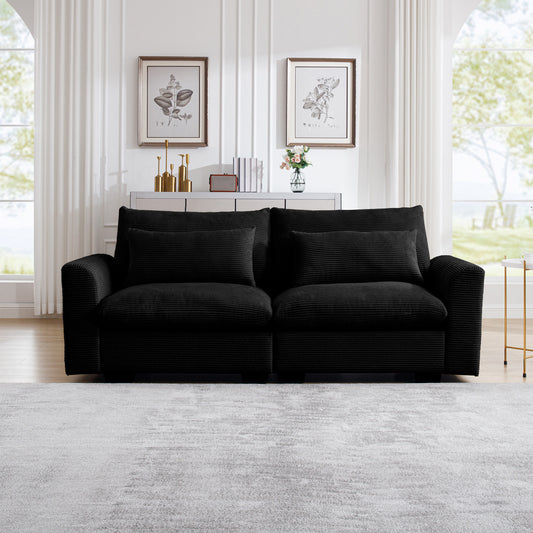Black corduroy sofa with plush throw pillows for a cozy living room