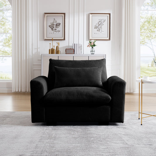 Cozy black corduroy armchair with plush back and accent pillows perfect for a modern living room