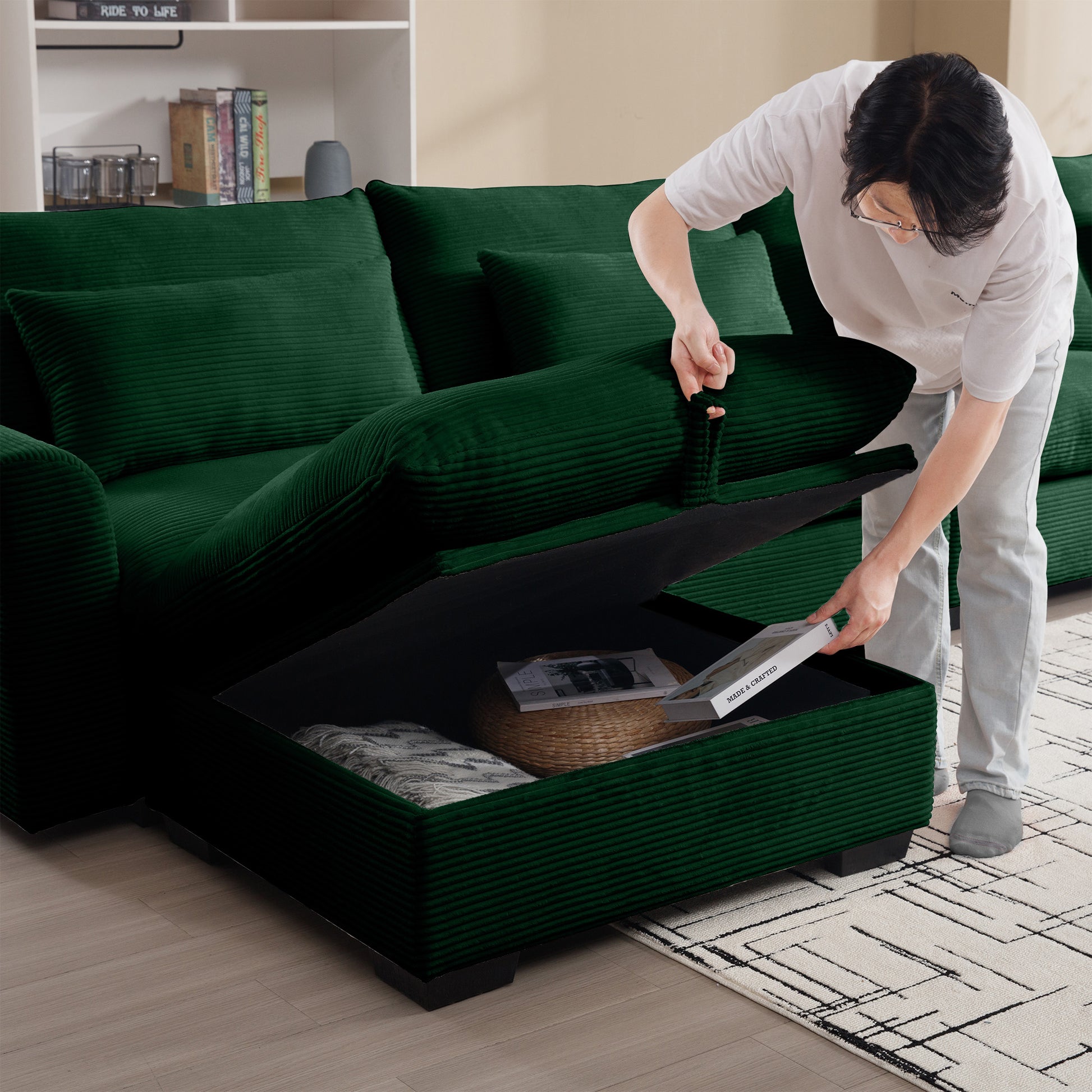 Deep green corduroy sectional sofa with hidden storage compartment for blankets and books
