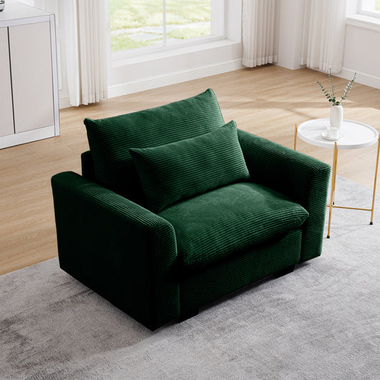 Plush emerald green corduroy armchair with deep seating and matching accent pillow