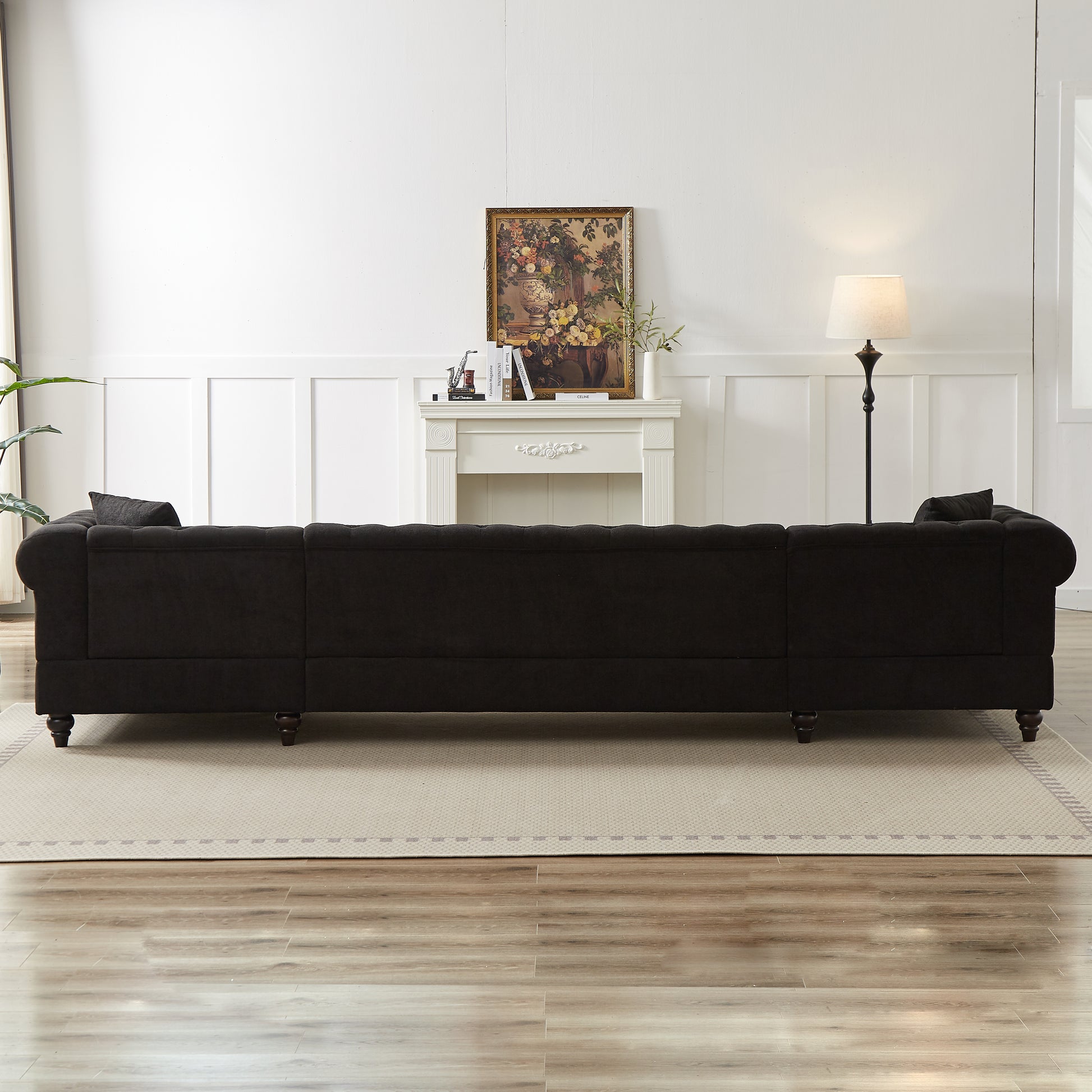 Dark charcoal tufted sectional sofa with plush fabric and dark wood legs