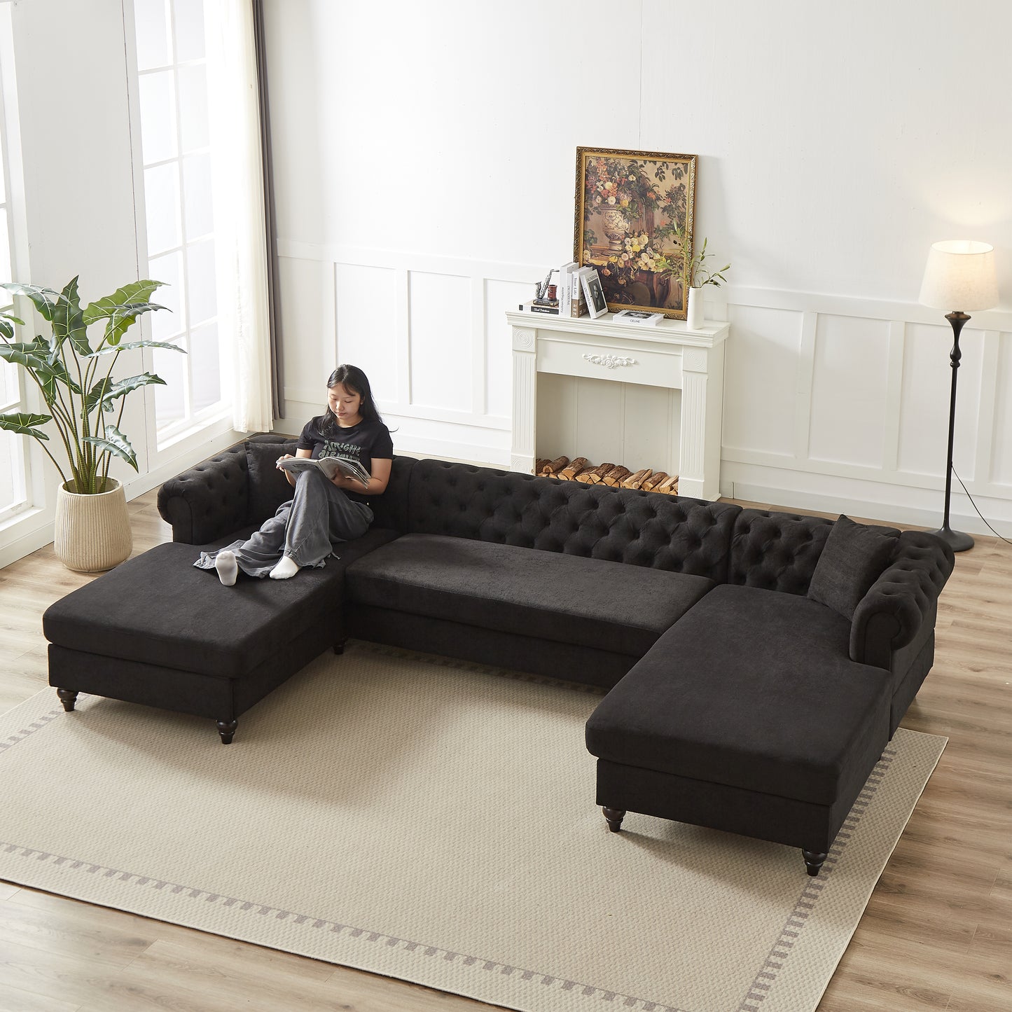 Dark charcoal fabric Chesterfield sectional sofa with tufted cushions and plush seats for a spacious living room