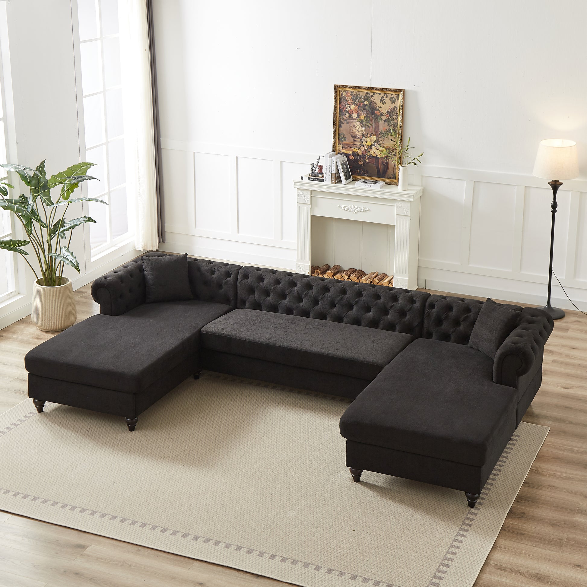 Dark gray tufted sectional sofa with chaise lounge and studded arms