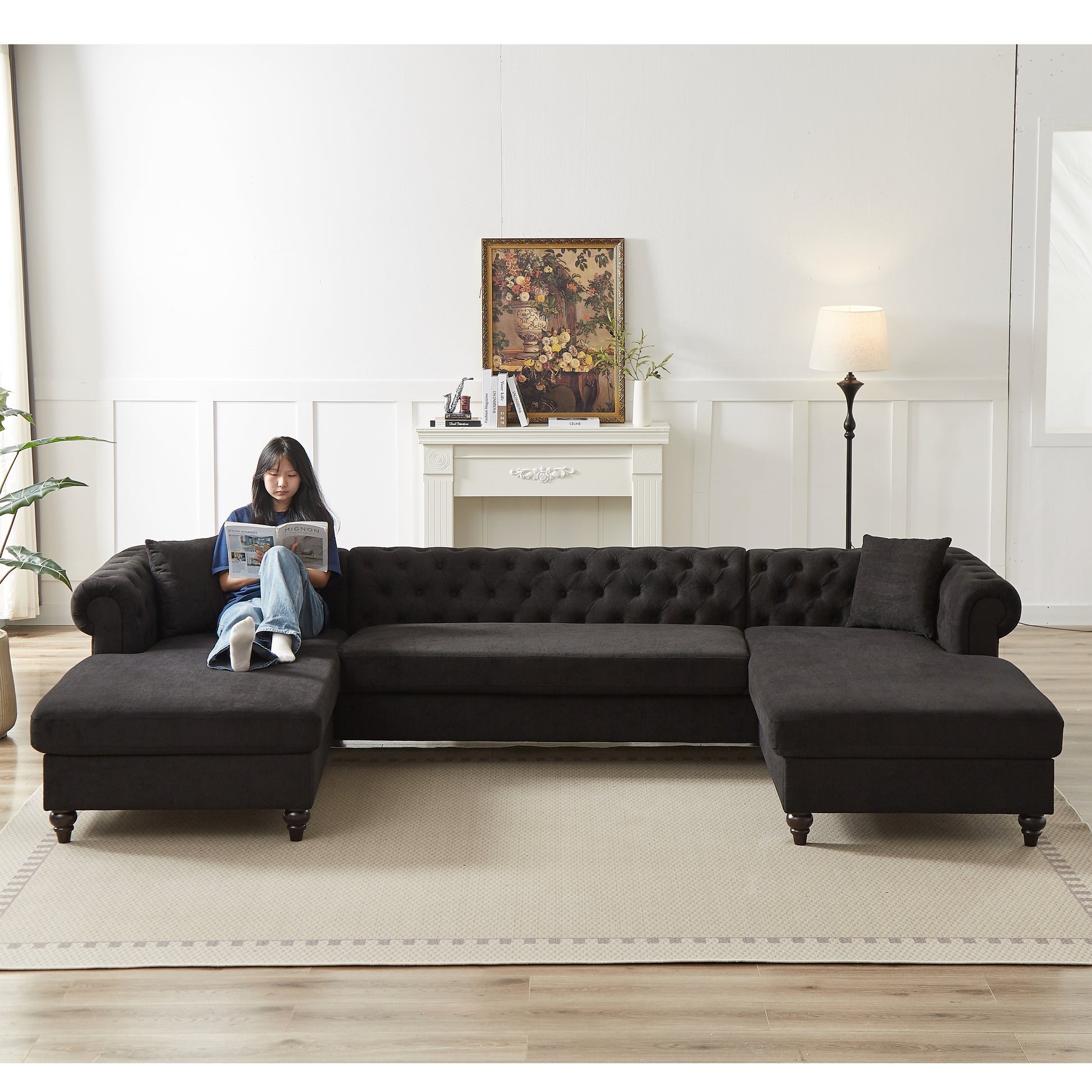 Dark charcoal tufted sectional sofa with chaise lounge and matching throw pillow