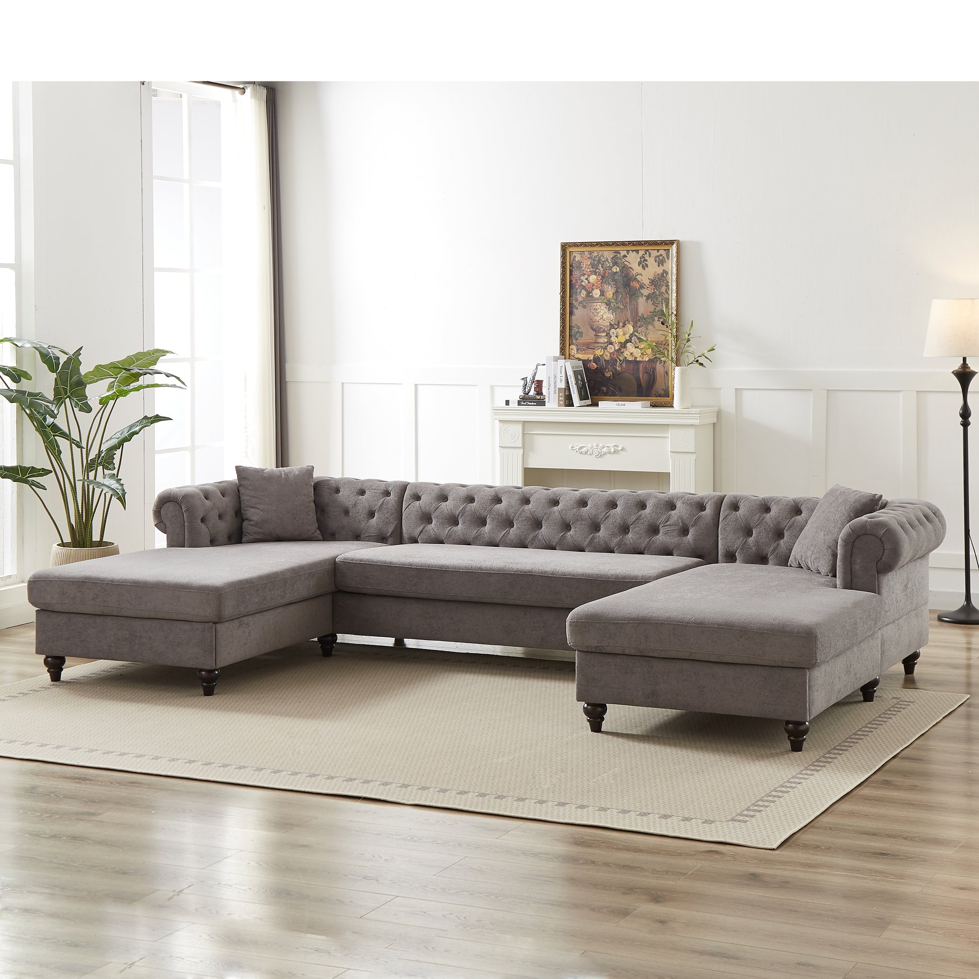 Dark gray tufted velvet sectional sofa with rolled arms and plush cushions perfect for spacious living rooms