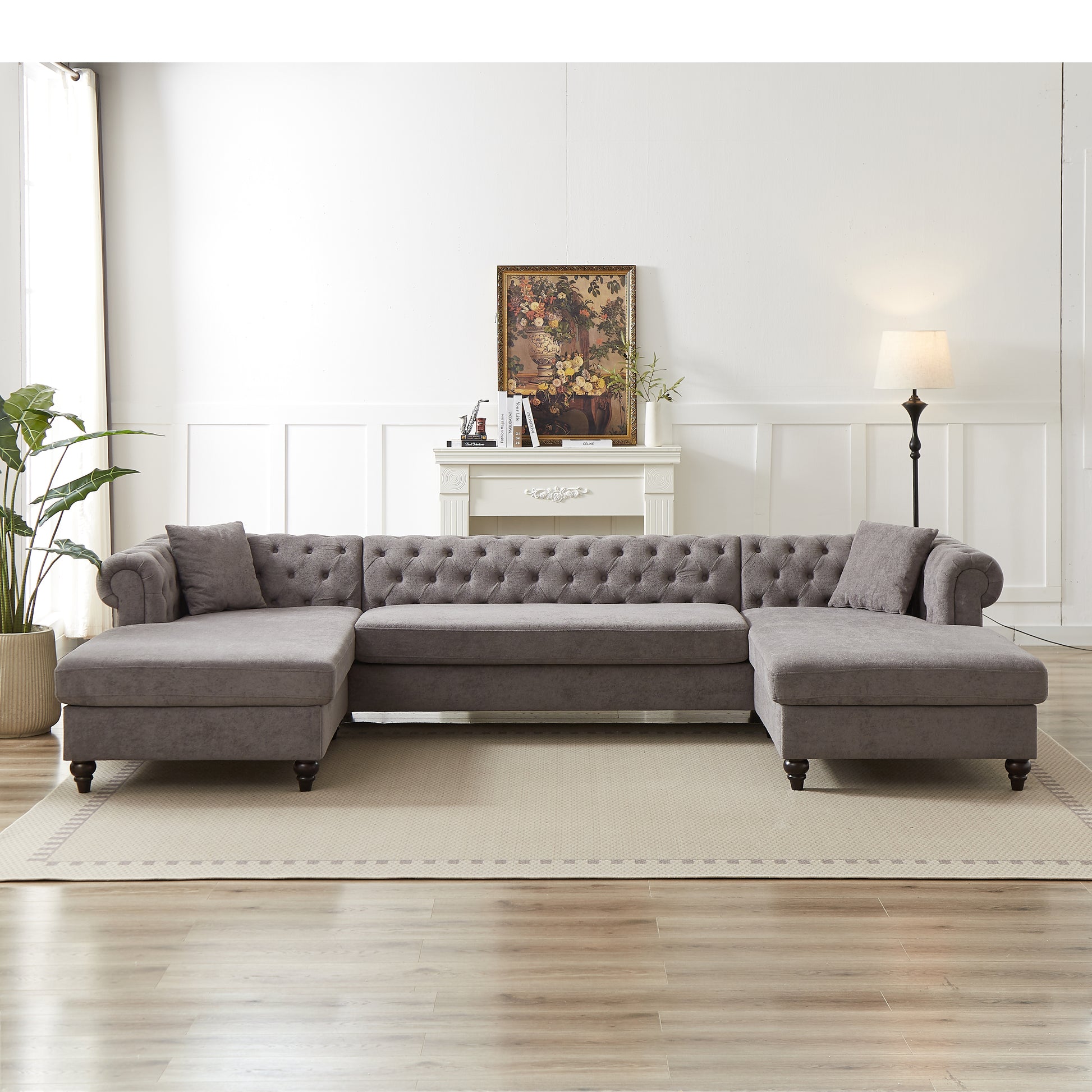 Gray tufted Ushaped sectional sofa with chaise lounge and accent pillows