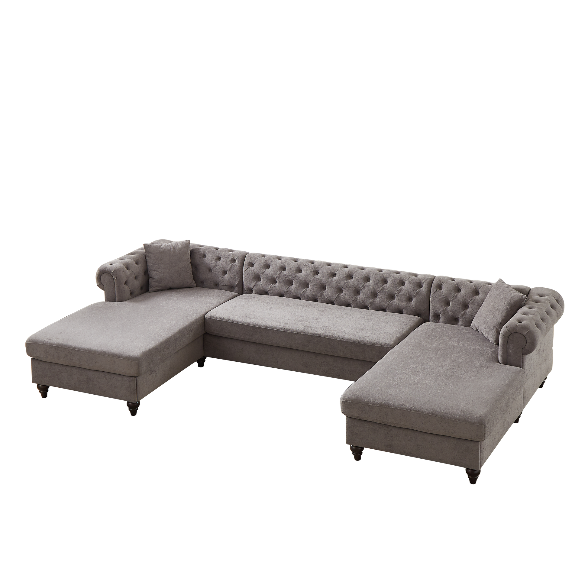 Plush grey velvet tufted Ushaped sectional sofa with rolled arms and decorative pillows