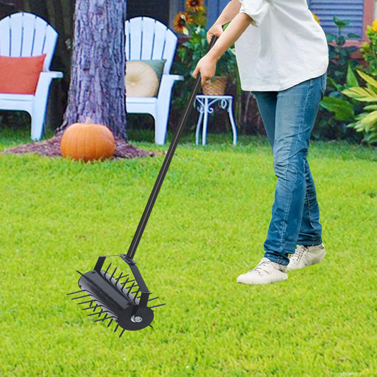 Black metal lawn aerator with long handle for garden use