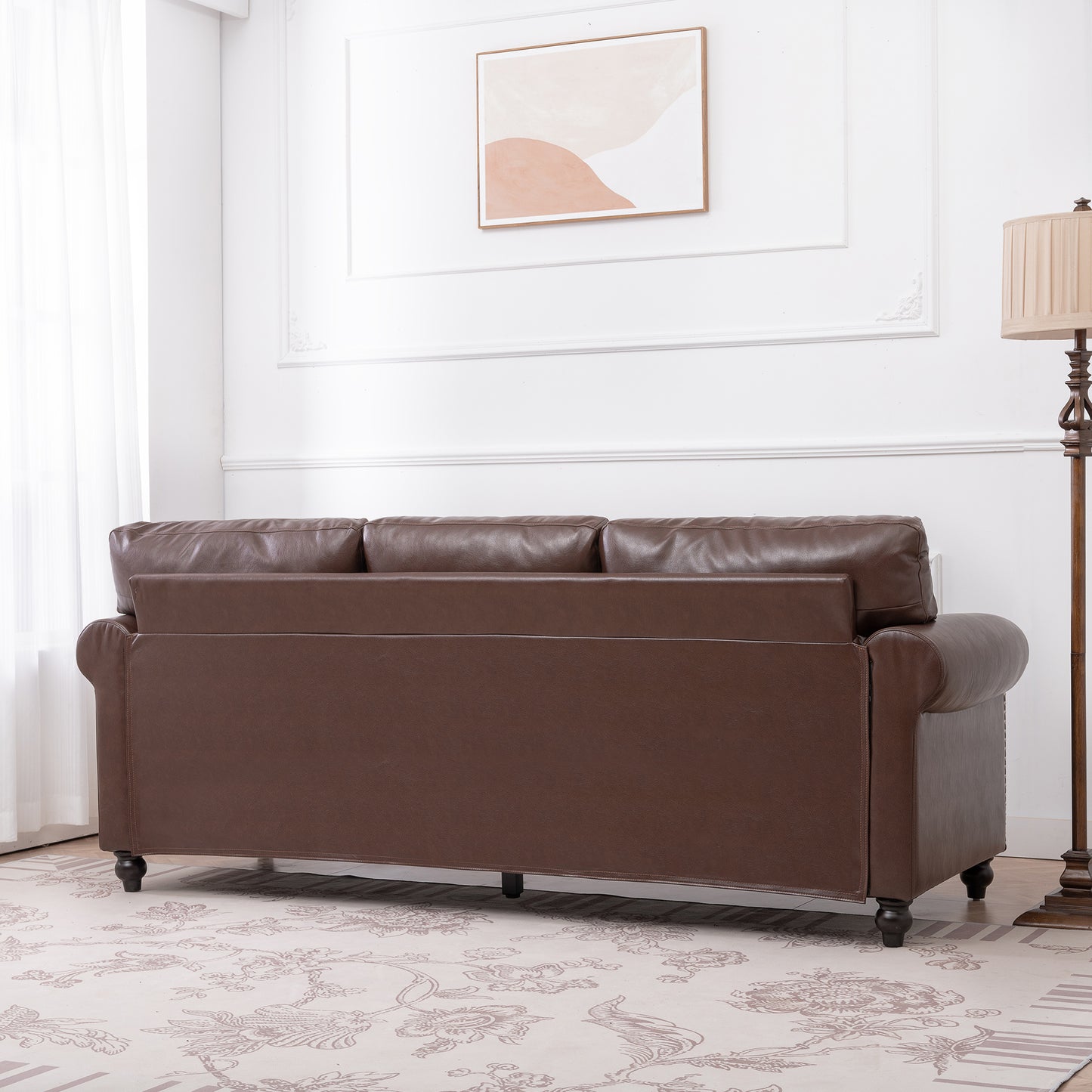 Elegant dark brown leather sofa with rolled arms perfect for a classic living room