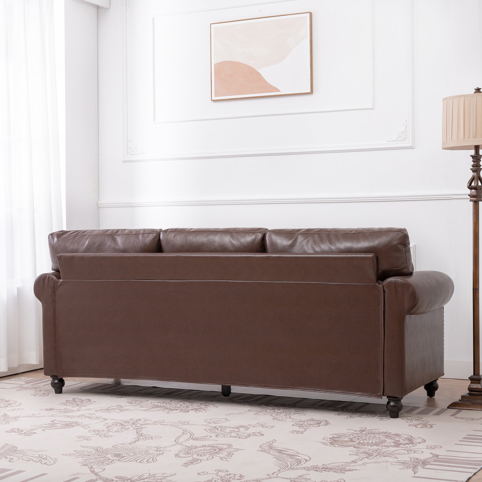 Elegant dark brown leather sofa with rolled arms perfect for a classic living room