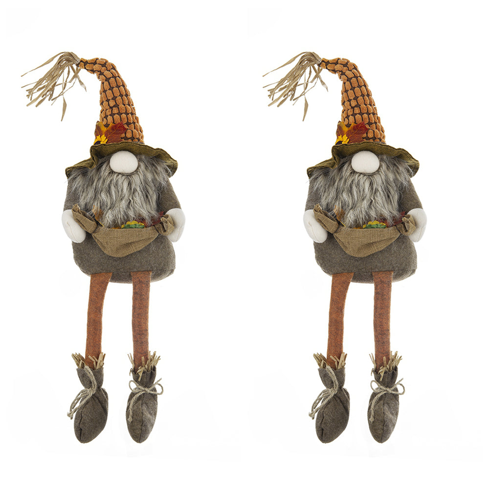 Two plush gnome figurines with tall orange patterned hats and long grey beards holding burlap sacks