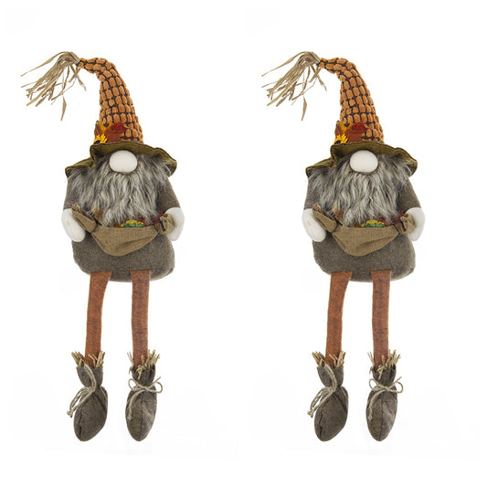 Two plush gnome figurines with tall orange patterned hats and long grey beards holding burlap sacks