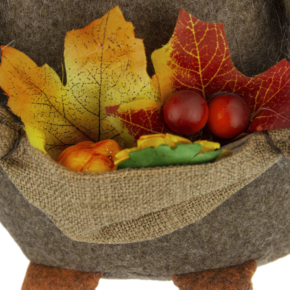 Autumn decorative accent with artificial leaves and berries in a burlap pouch