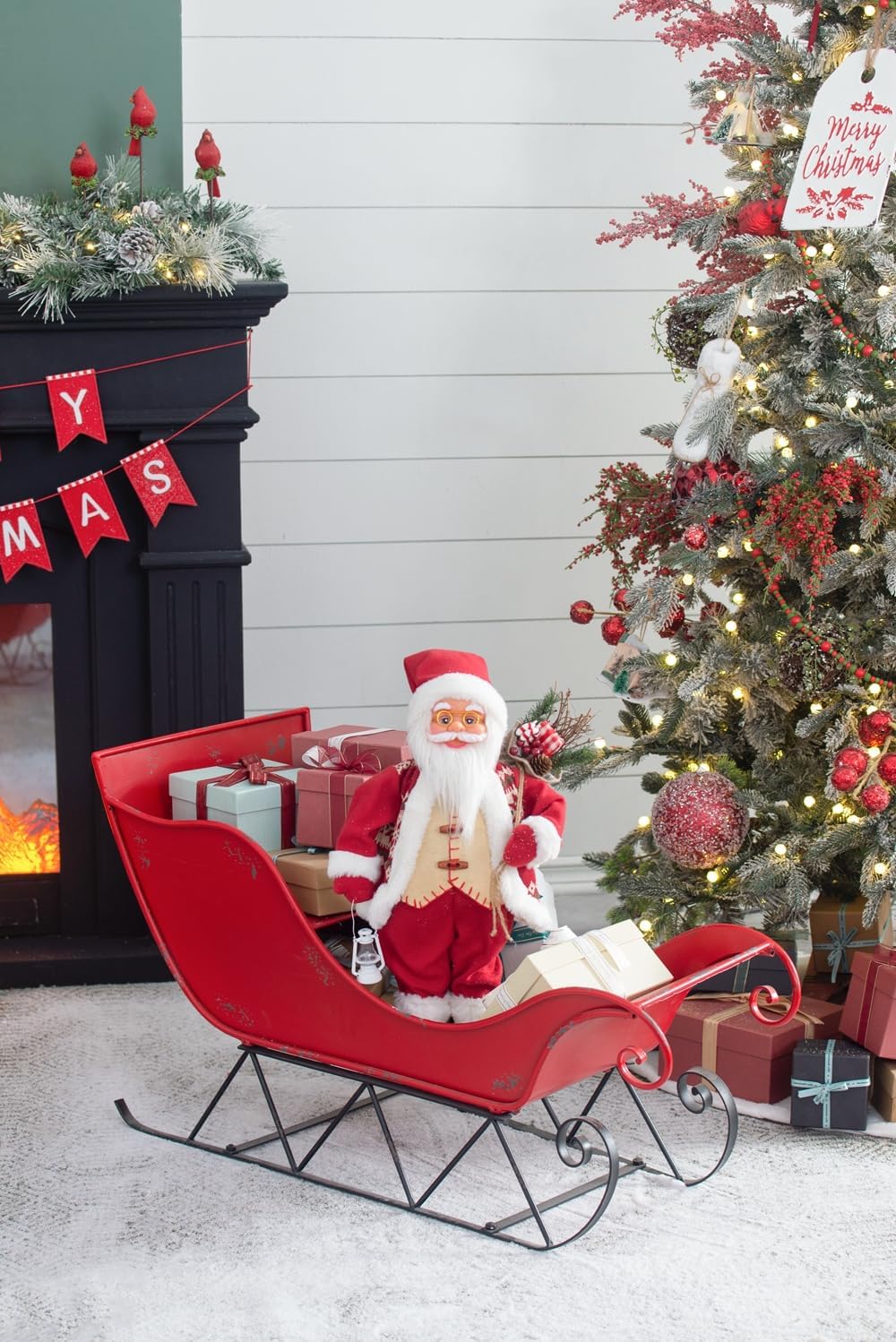 Santa Claus figure in a red sleigh filled with gifts festive holiday decor