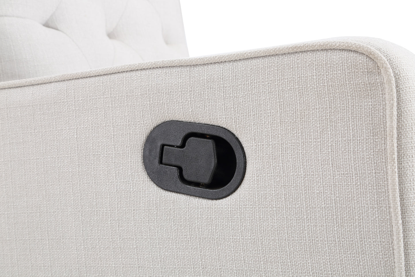 Closeup of a beige fabric recliner lever with tufted details on the chair back