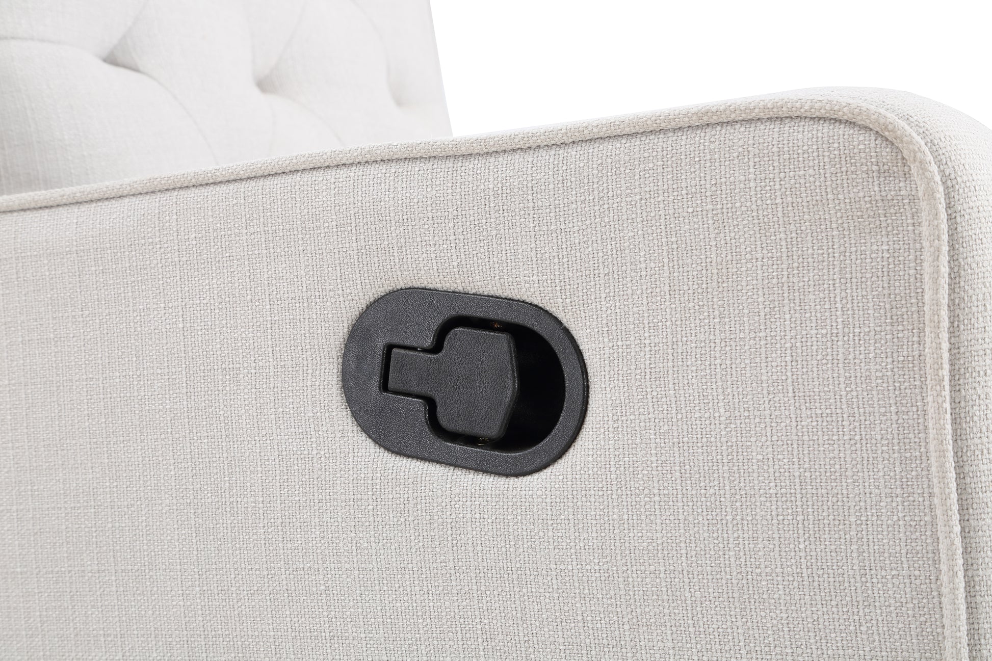 Closeup of a beige fabric recliner lever with tufted details on the chair back