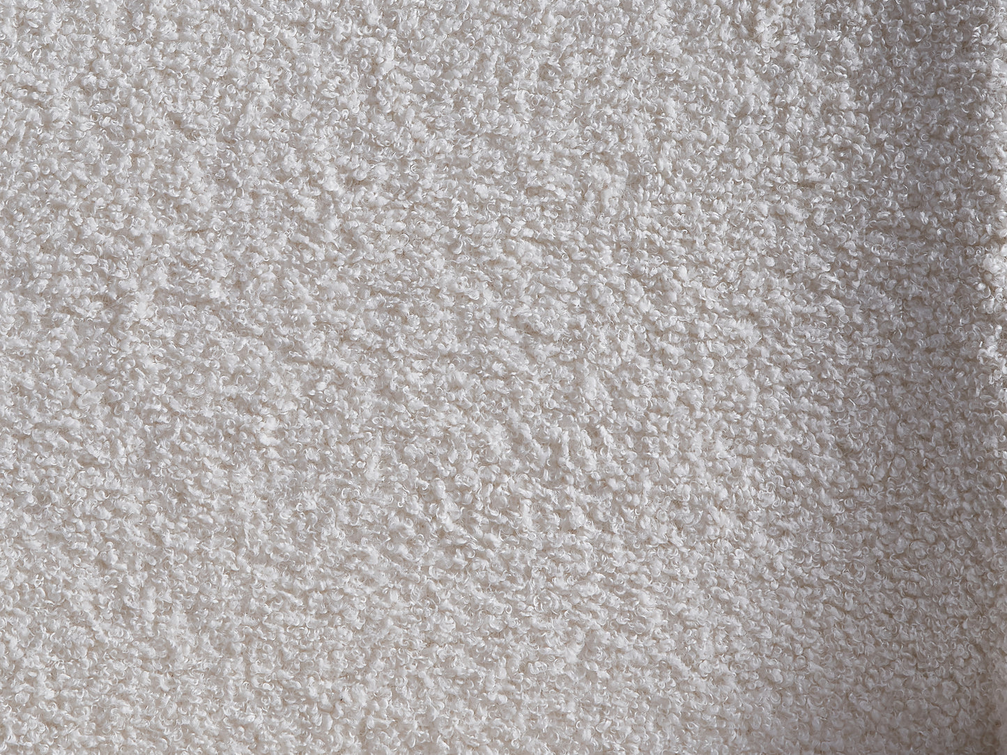 Closeup of a soft white teddy fleece fabric with a curly texture perfect for cozy blankets