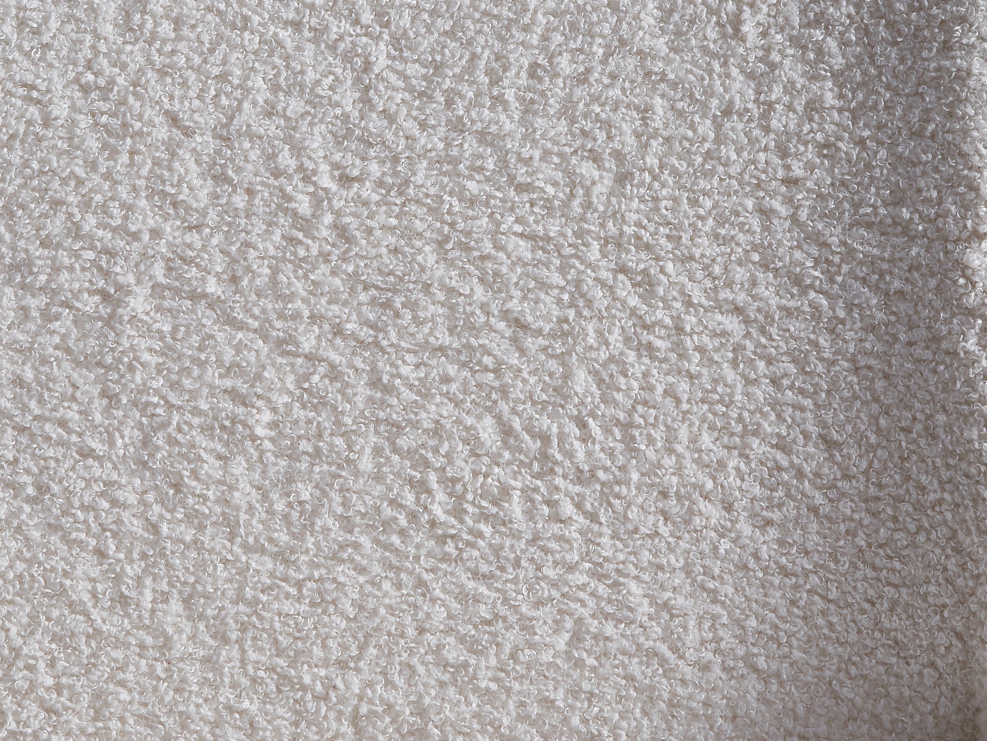 Closeup of a soft white teddy fleece fabric with a curly texture perfect for cozy blankets