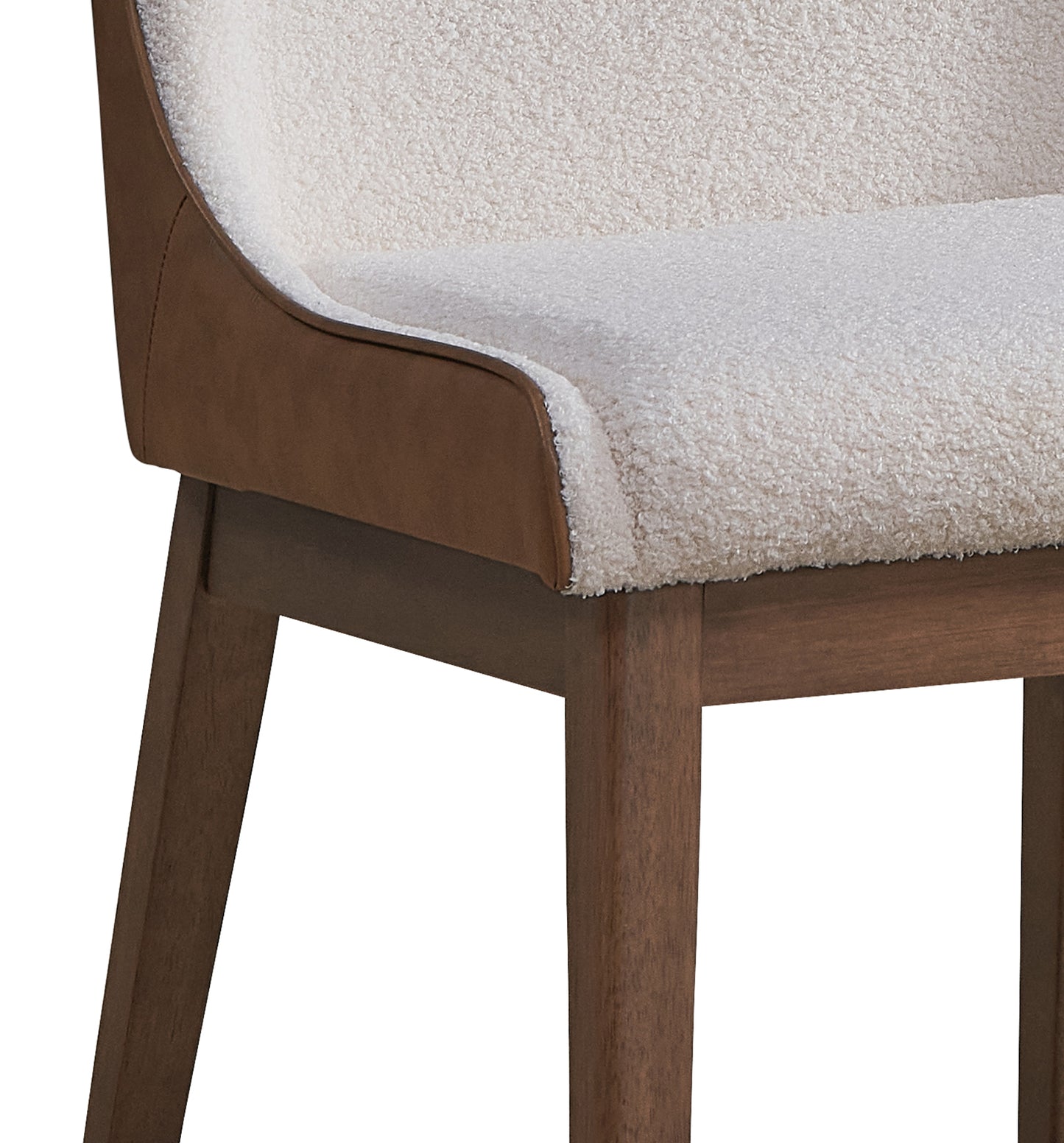 Textured ivory boucle fabric on a curved seat and back with brown faux leather trim and dark wood legs for a modern accent chair